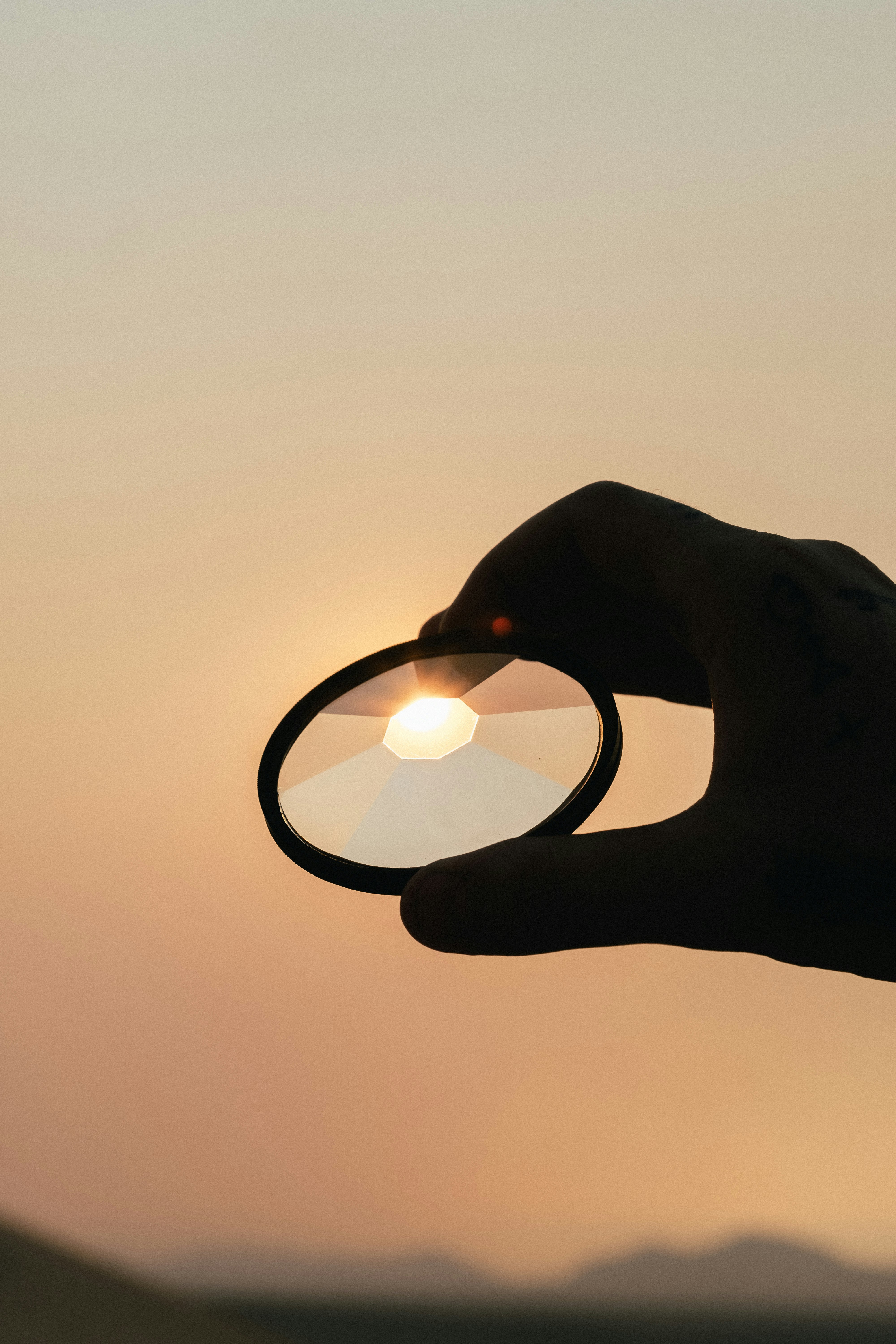 person holding round glass with light